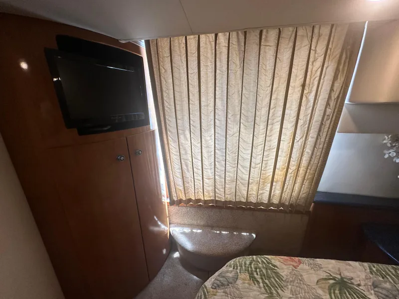 Slide: The Image of Interior of 2002 Carver 444 Cockpit Motor Yacht with TV and window blinds. - 24