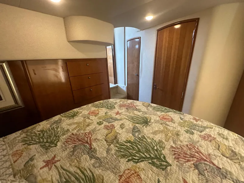 Slide: The Image of Interior cabin of 2002 Carver 444 Cockpit Motor Yacht with floral bedspread. - 26