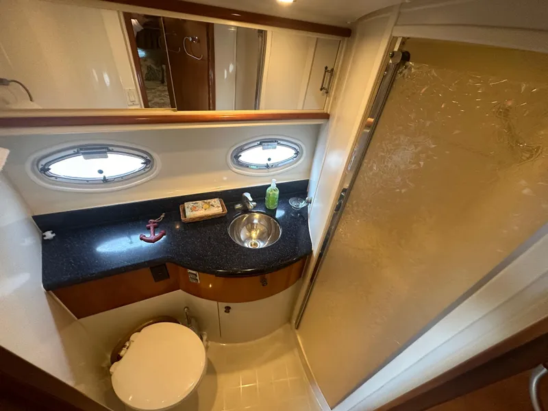 Slide: The Image of 2002 Carver 444 Cockpit Motor Yacht bathroom with sink, toilet, and shower. - 28
