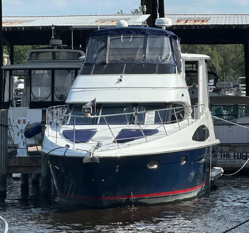 Slide: The Image of 2002 Carver 444 Cockpit Motor Yacht docked at a marina. - 4