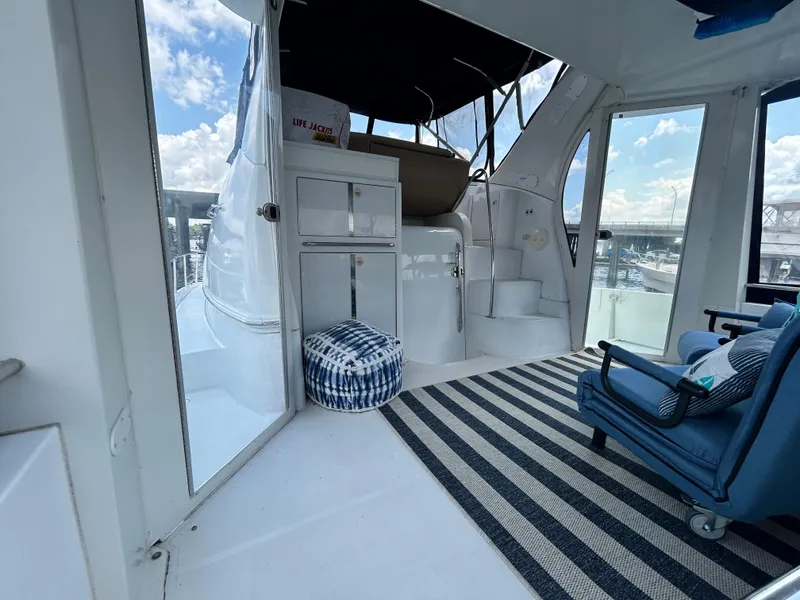 Slide: The Image of 2002 Carver 444 Cockpit Motor Yacht interior with seating and striped rug. - 8