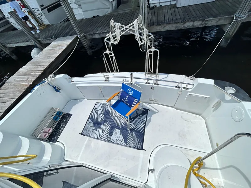 Slide: The Image of 2002 Carver 444 Cockpit Motor Yacht with a deck chair and rug on the cockpit. - 9