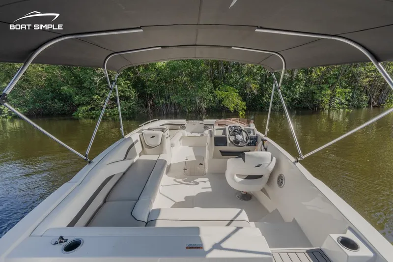 Slide: The Image of 2023 Starcraft SVX 211 OB boat interior with canopy on calm water. - 5