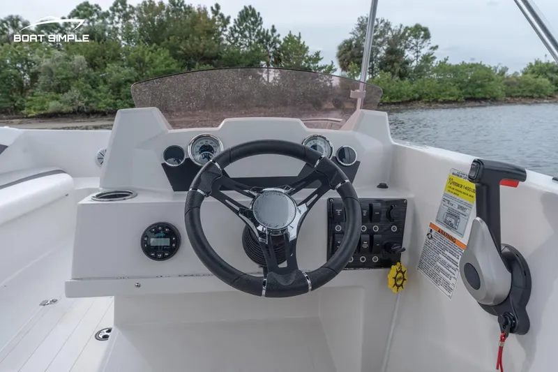 Slide: The Image of 2022 Starcraft SVX 171 OB boat dashboard with steering wheel and controls. - 5