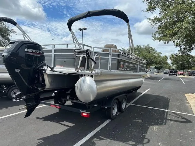 The Image of 2024 Sun Tracker Fishin' Barge 20 DLX pontoon boat in parking lot. - 0