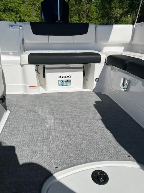 Slide: The Image of 2024 Tahoe 2150 boat interior with seating and Igloo cooler. - 11