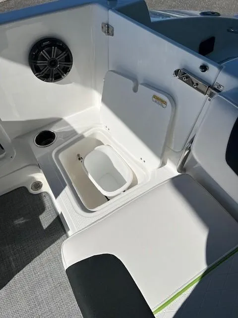 Slide: The Image of 2024 Tahoe 2150 boat interior with storage compartment and speaker. - 14