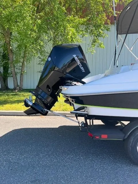 Slide: The Image of 2024 Tahoe 2150 boat with Mercury outboard motor on trailer. - 2