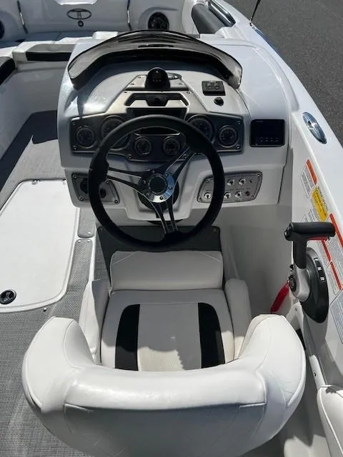 Slide: The Image of 2024 Tahoe 2150 boat cockpit with steering wheel and control panel. - 8