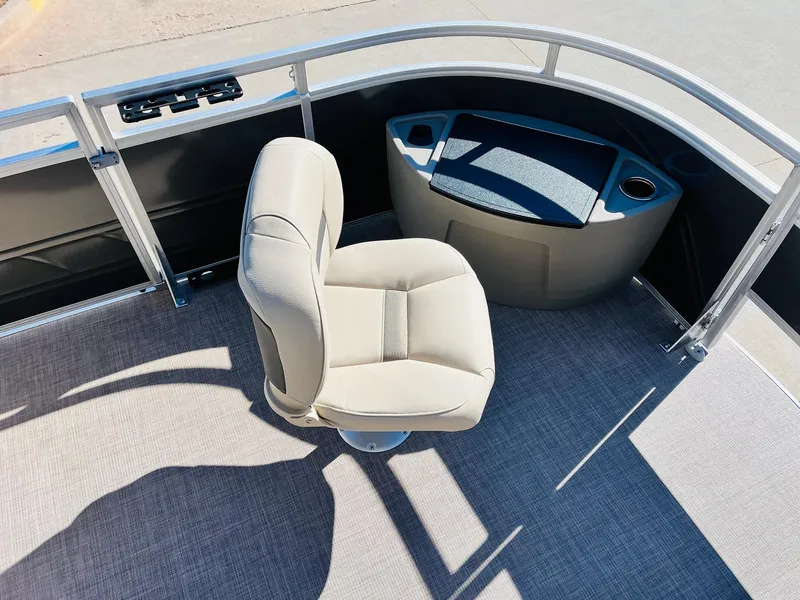 Slide: The Image of 2024 Sun Tracker Fishin' Barge 20 DLX interior with captain's chair and console. - 10