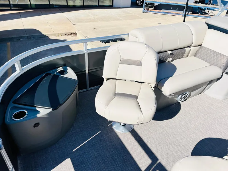 Slide: The Image of 2024 Sun Tracker Fishin' Barge 20 DLX interior with seating and storage. - 12