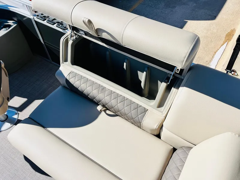 Slide: The Image of 2024 Sun Tracker Fishin' Barge 20 DLX storage compartment with cushioned seating. - 17