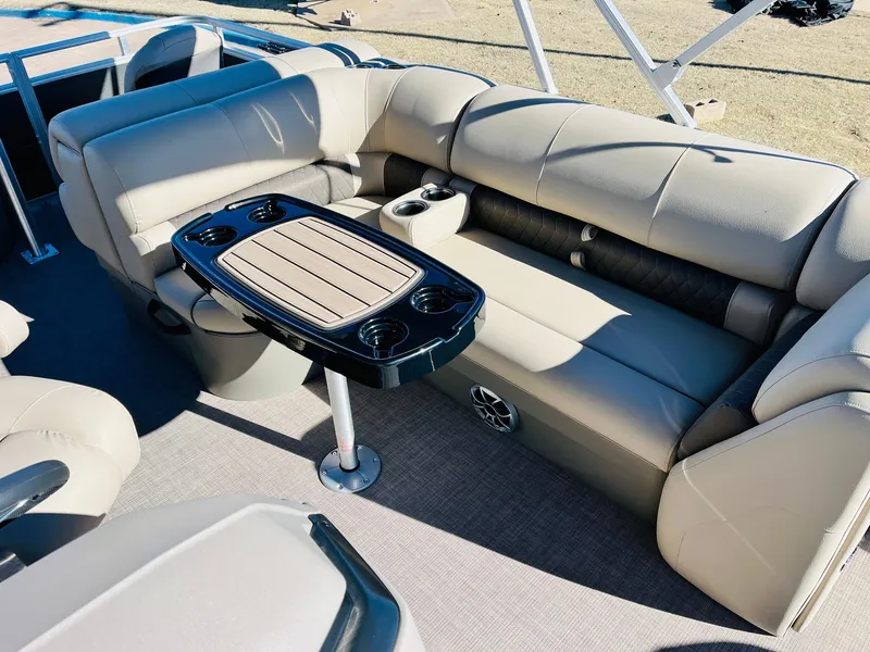 Slide: The Image of 2024 Sun Tracker Fishin' Barge 20 DLX interior seating with table and cup holders. - 19