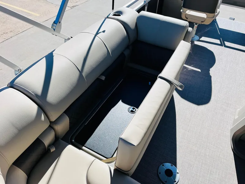 Slide: The Image of 2024 Sun Tracker Fishin' Barge 20 DLX interior seating with storage compartment. - 21