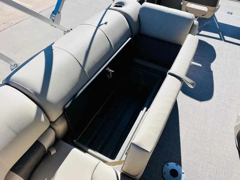 Slide: The Image of 2024 Sun Tracker Fishin' Barge 20 DLX boat with open storage compartment. - 22