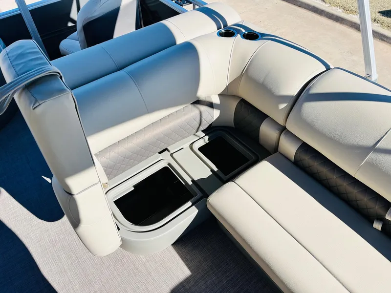 Slide: The Image of 2024 Sun Tracker Fishin' Barge 20 DLX interior seating with storage compartments. - 24
