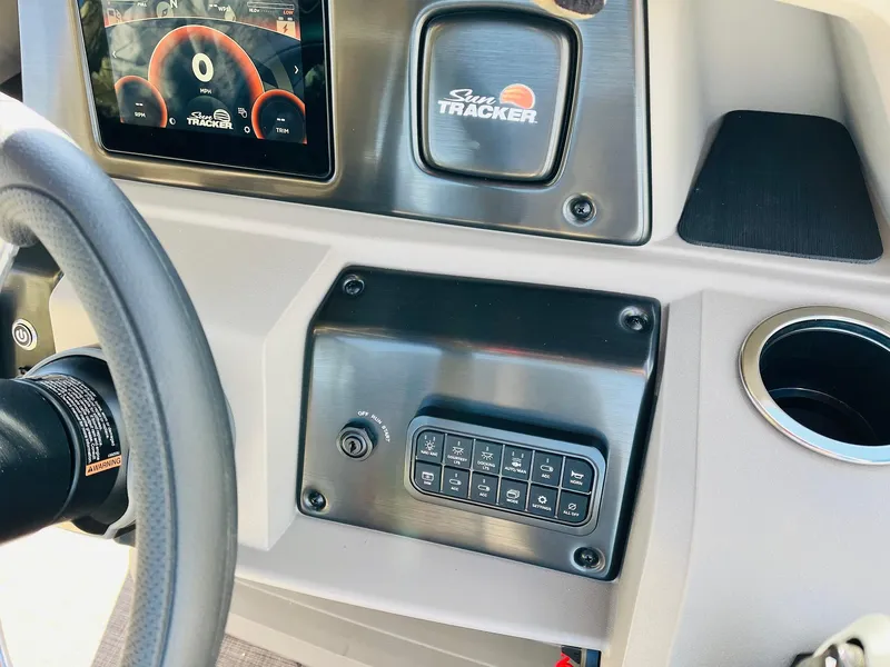 Slide: The Image of Dashboard of 2024 Sun Tracker Fishin' Barge 20 DLX with control panel and display. - 30