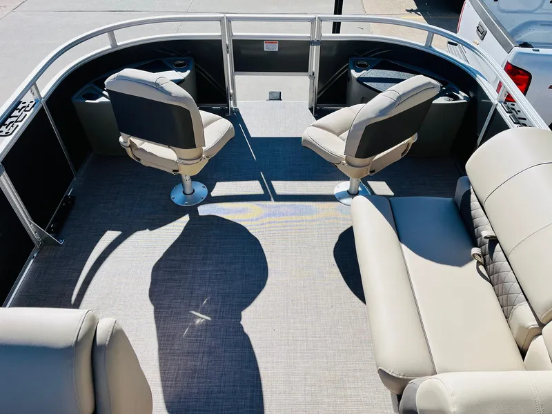 Slide: The Image of 2024 Sun Tracker Fishin' Barge 20 DLX interior with seating and fishing chairs. - 9