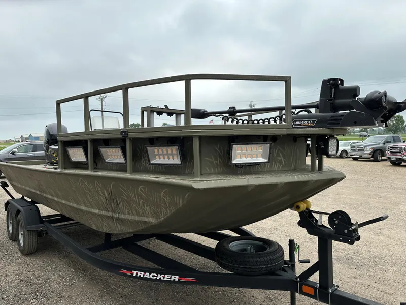The Image of 2024 Tracker Grizzly 2072 CC Sportsman Kicker boat on trailer, featuring camouflage design. - 0