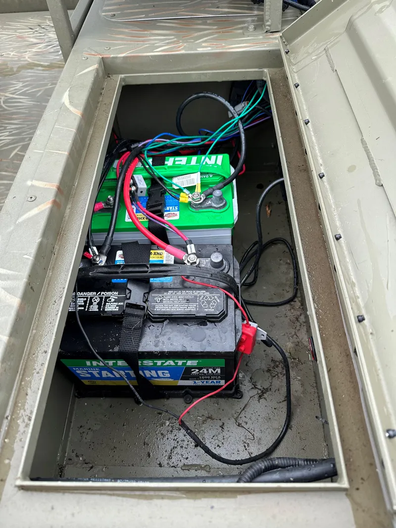 Slide: The Image of 2024 Tracker Grizzly 2072 CC Sportsman Kicker boat battery compartment with wiring. - 3