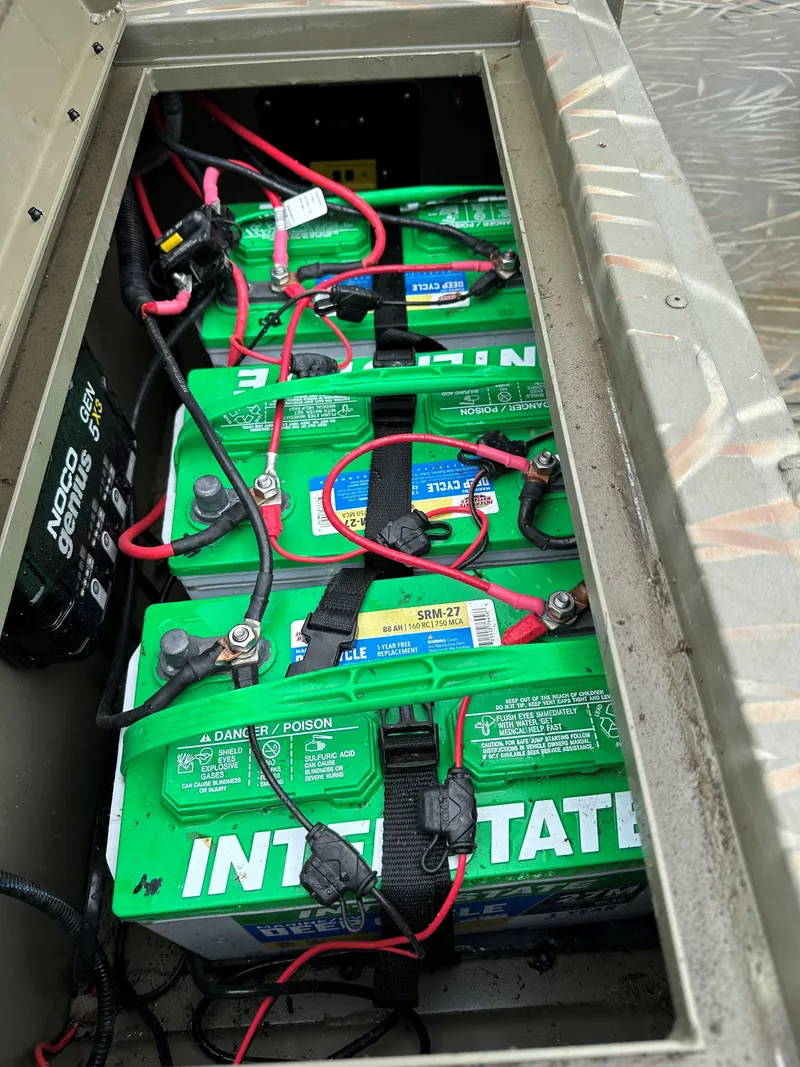 Slide: The Image of Batteries in a 2024 Tracker Grizzly 2072 CC Sportsman Kicker boat compartment. - 4