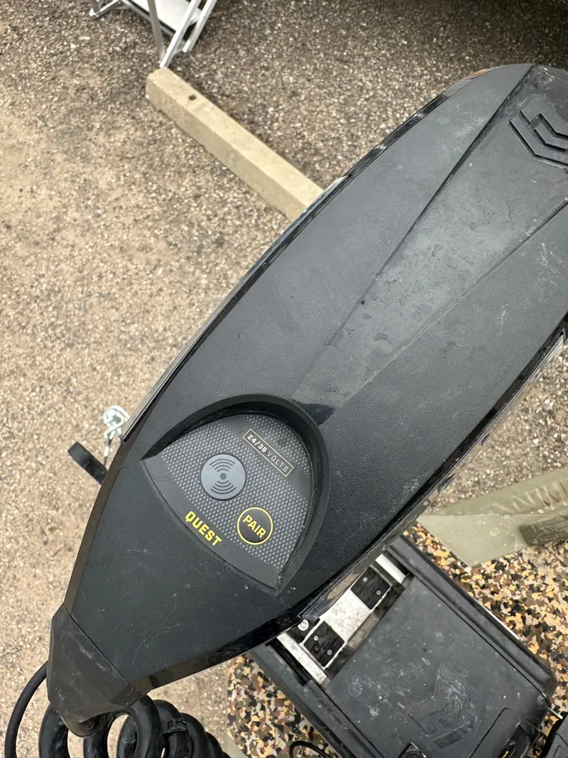 Slide: The Image of 2024 Tracker Grizzly 2072 CC Sportsman Kicker motor, top view, on gravel surface. - 8