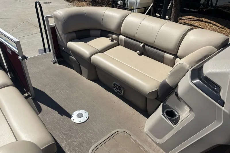 Slide: The Image of 2024 Sun Tracker Party Barge 22 RF XP3 interior with beige seating and cup holder. - 9