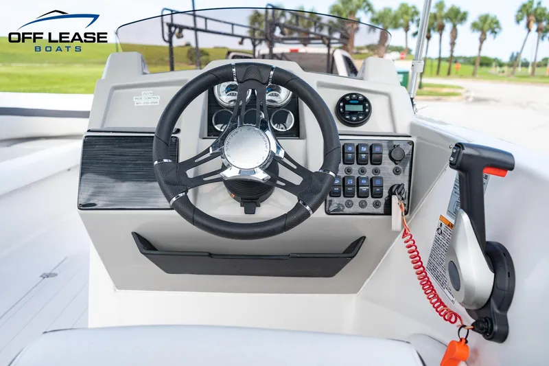 Slide: The Image of 2022 Starcraft SVX 191 OB boat dashboard with steering wheel and control panel. - 2
