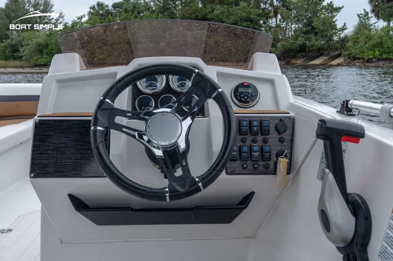 Slide: The Image of 2022 Starcraft SVX 211 OB boat dashboard with steering wheel and control panel. - 7