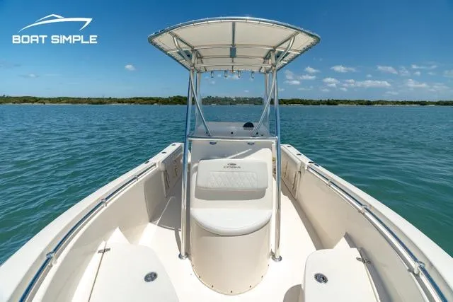 Slide: The Image of 2021 Cobia 201 Center Console boat on calm blue water under clear sky. - 7