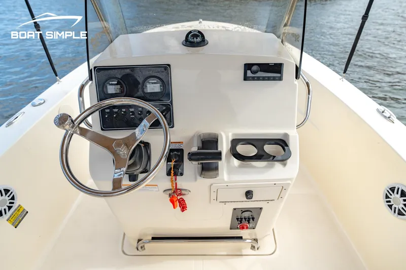 Slide: The Image of 2021 Scout 195 Sportfish boat console with steering wheel and controls. - 7