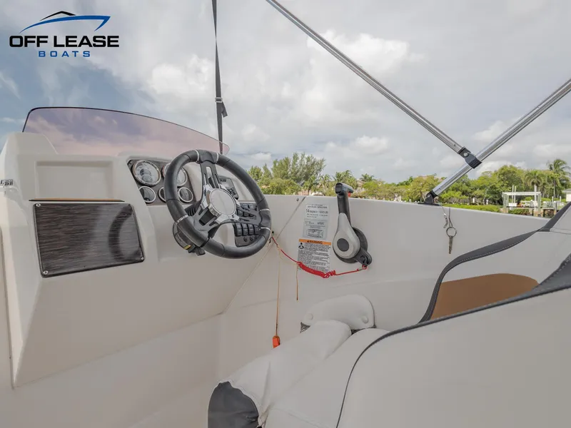 Slide: The Image of 2021 Starcraft SVX 231 OB boat cockpit with steering wheel and controls. - 7