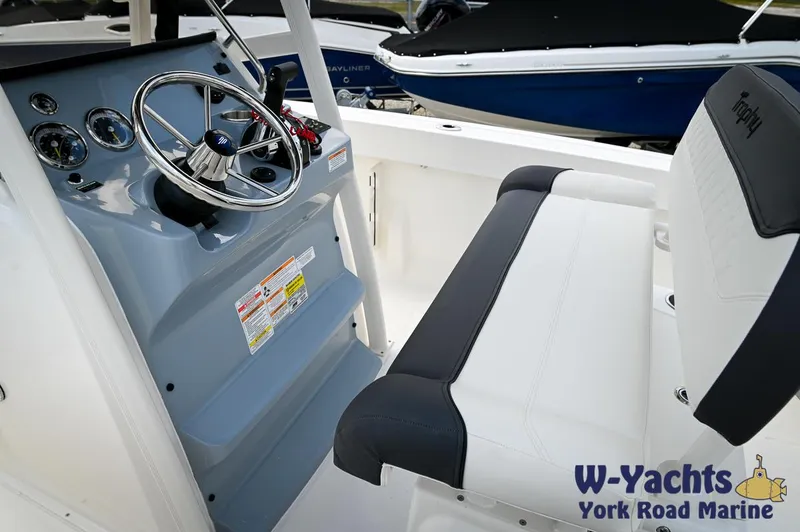 Slide: The Image of 2024 Bayliner Trophy T22CC boat interior with steering wheel and seating, W-Yachts York Road Marine. - 12
