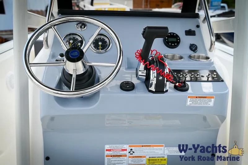 Slide: The Image of 2024 Bayliner Trophy T22CC boat console with steering wheel and controls, W-Yachts York Road Marine. - 13