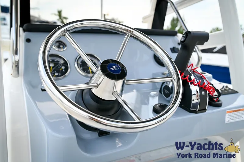 Slide: The Image of 2024 Bayliner Trophy T22CC boat steering console with gauges and throttle. - 15