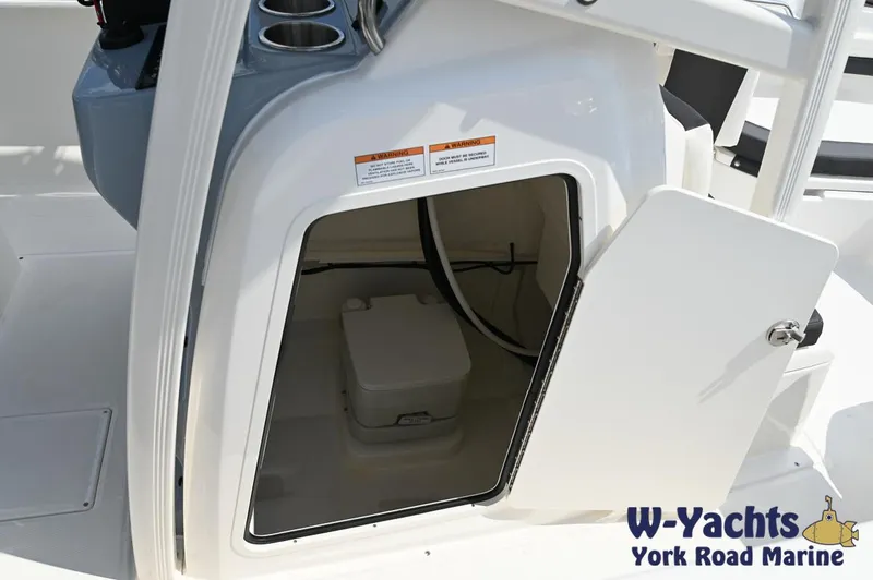 Slide: The Image of 2024 Bayliner Trophy T22CC storage compartment with open door at W-Yachts York Road Marine. - 17