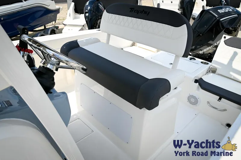 Slide: The Image of 2024 Bayliner Trophy T22CC boat interior with steering wheel and seating. - 18