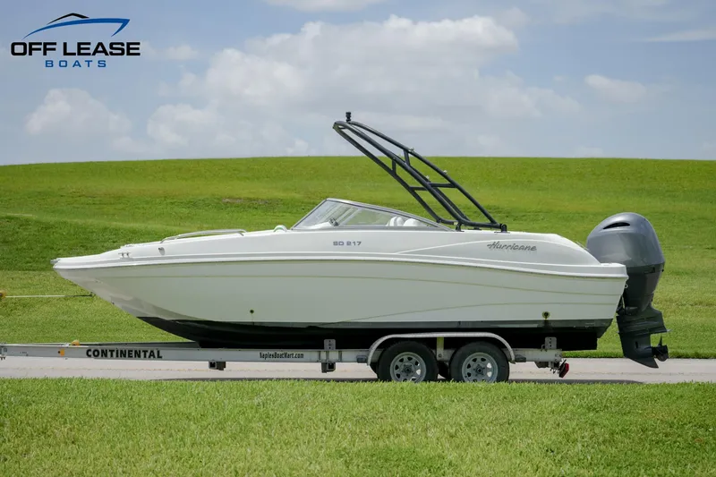 Slide: The Image of 2020 Hurricane 217 SD boat on Continental trailer, side view, green grass background. - 6