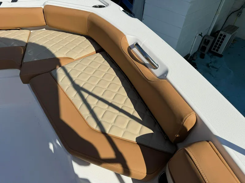 Slide: The Image of 2024 NauticStar 191 Hybrid boat with tan and beige cushioned seating. - 12