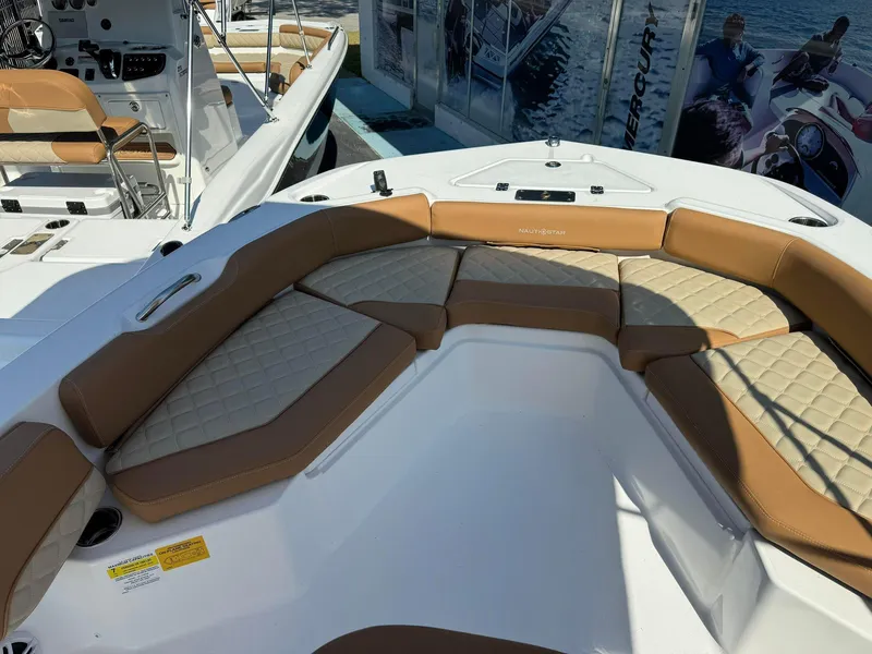 Slide: The Image of 2024 NauticStar 191 Hybrid boat with tan and white cushioned seating. - 3