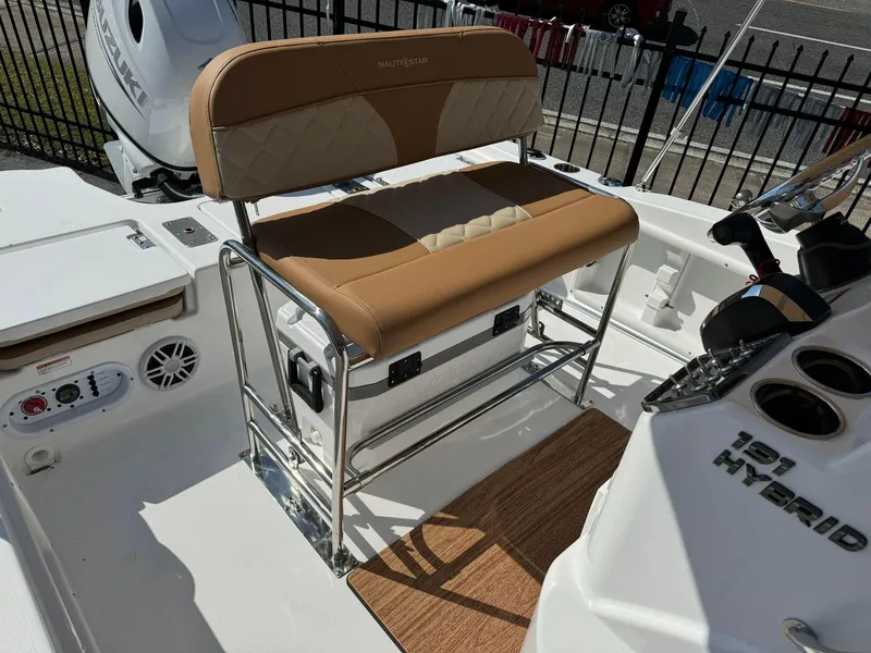 Slide: The Image of 2024 NauticStar 191 Hybrid boat interior with tan seating and control panel. - 4