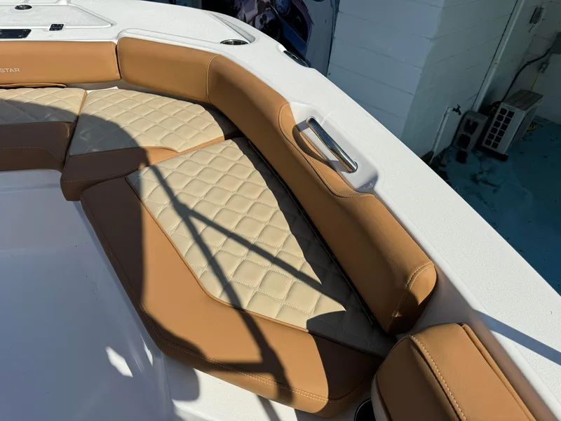 Slide: The Image of 2024 NauticStar 191 Hybrid boat with tan and beige cushioned seating. - 8