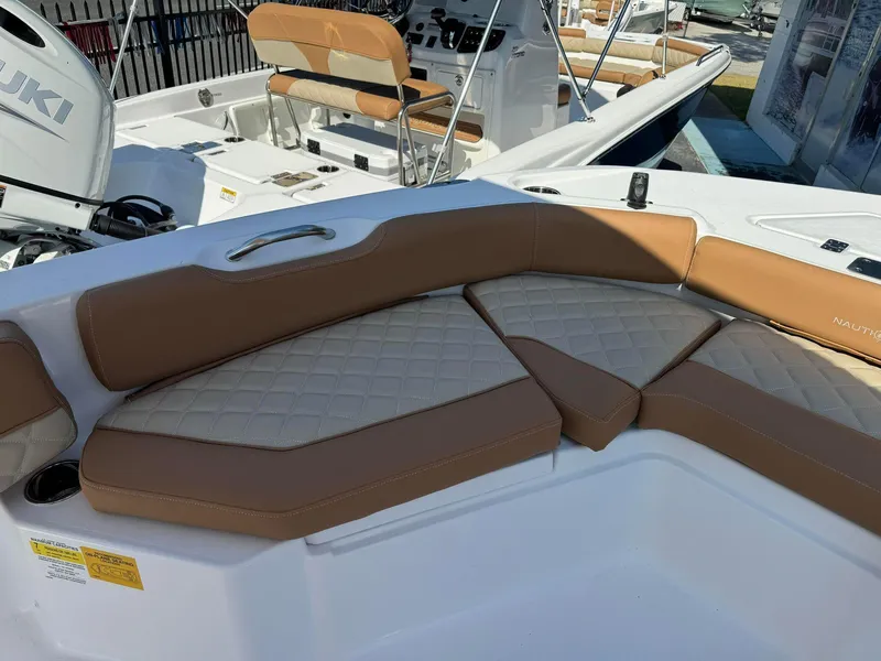 Slide: The Image of 2024 NauticStar 191 Hybrid boat with tan and cream cushioned seating. - 9