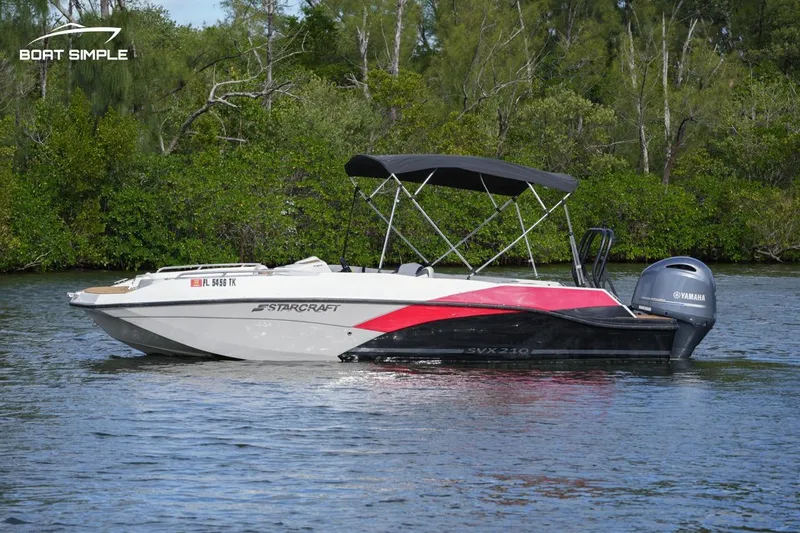 Slide: The Image of 2023 Starcraft SVX 210 OB boat on water with Yamaha outboard motor. - 1