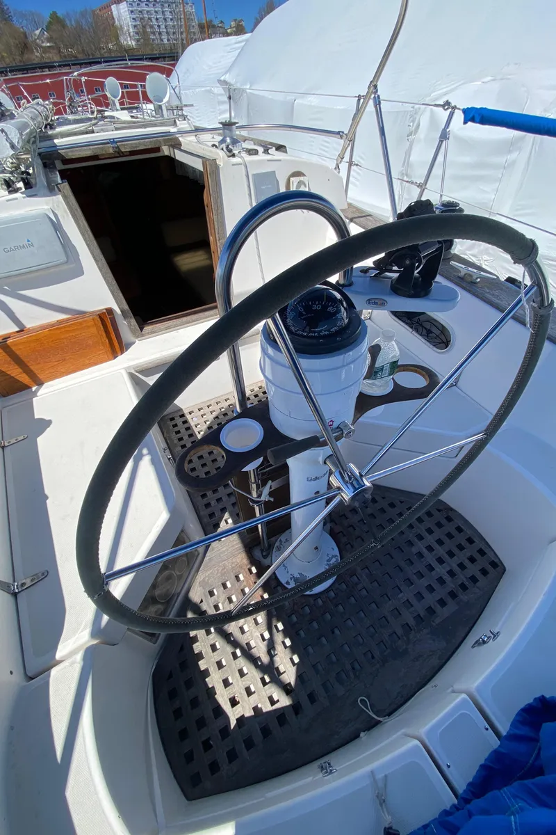 Slide: The Image of 1985 Sabre 32 sailboat cockpit with steering wheel and navigation instruments. - 10