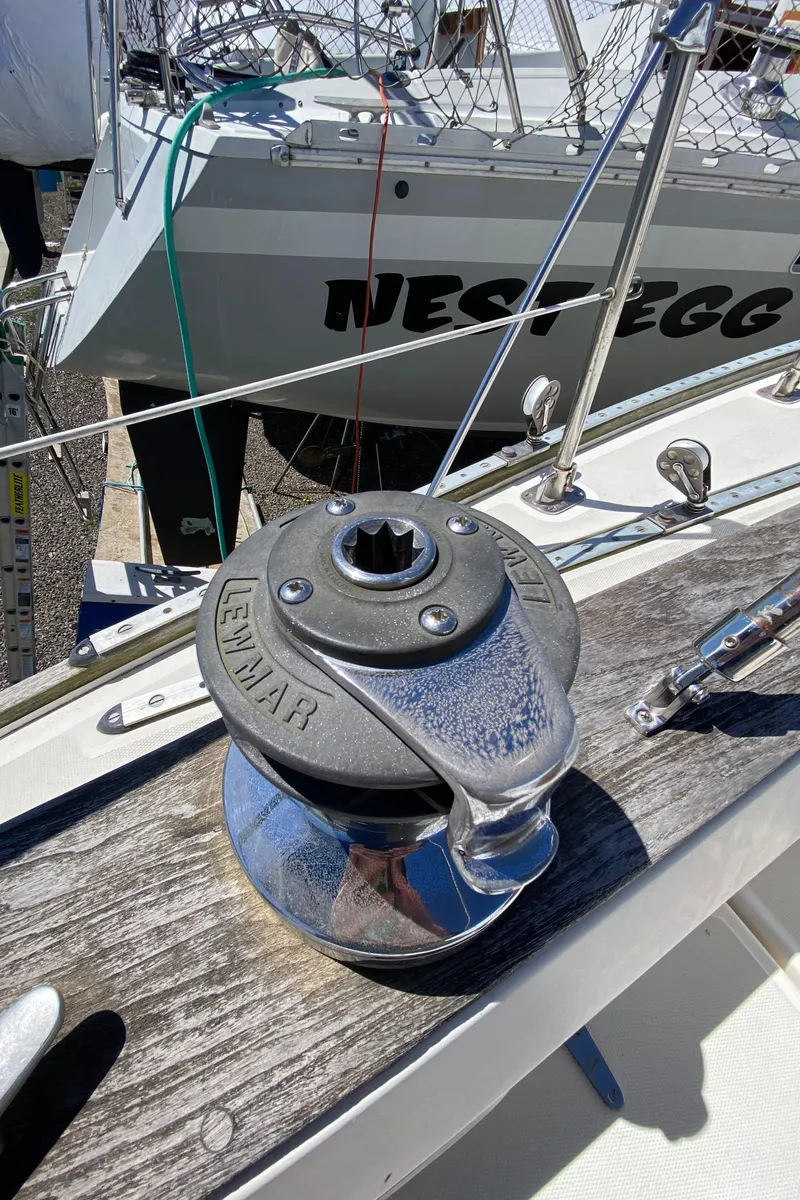 Slide: The Image of Winch on 1985 Sabre 32 sailboat deck with Nest Egg boat in background. - 14