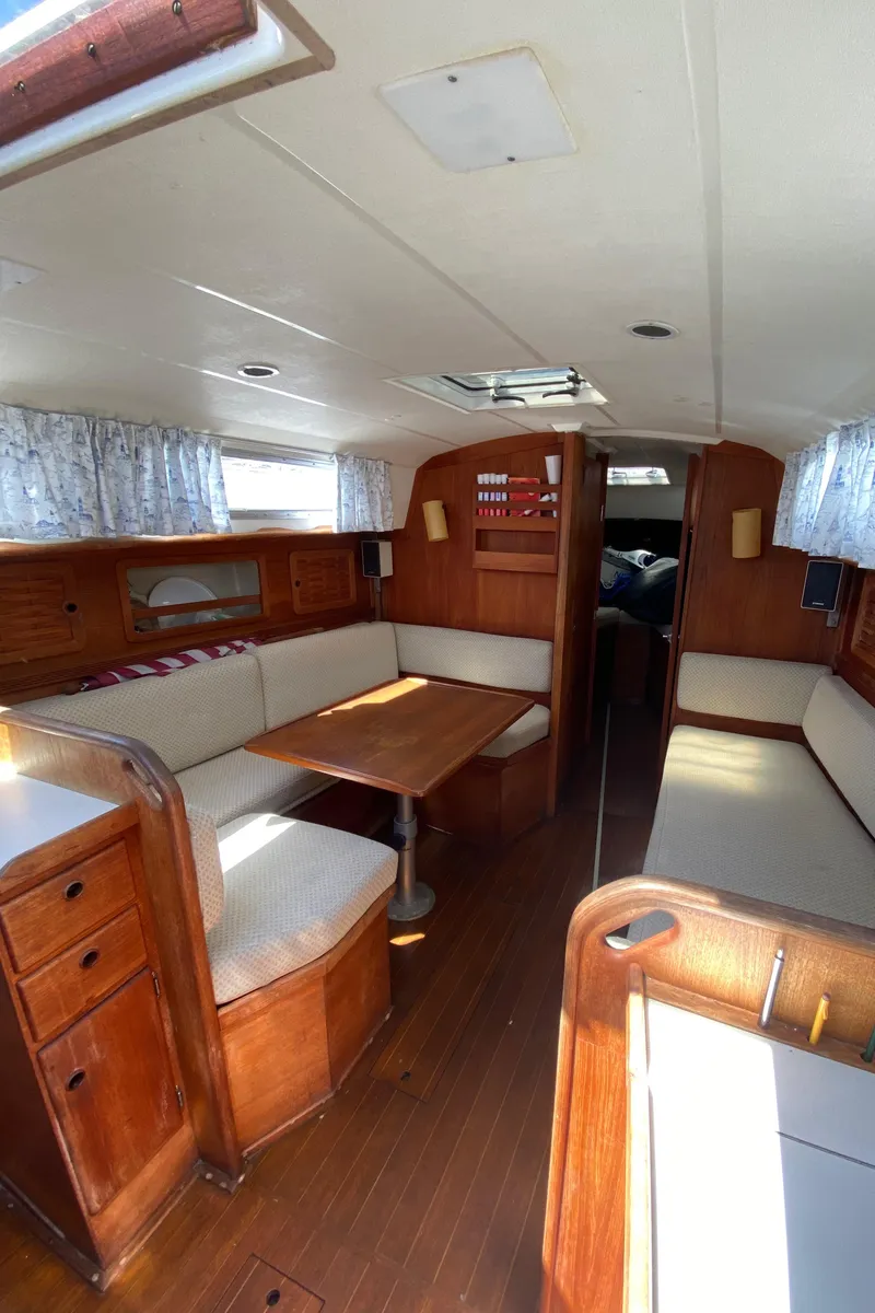 Slide: The Image of Interior of a 1985 Sabre 32 sailboat with wooden furnishings and seating area. - 16