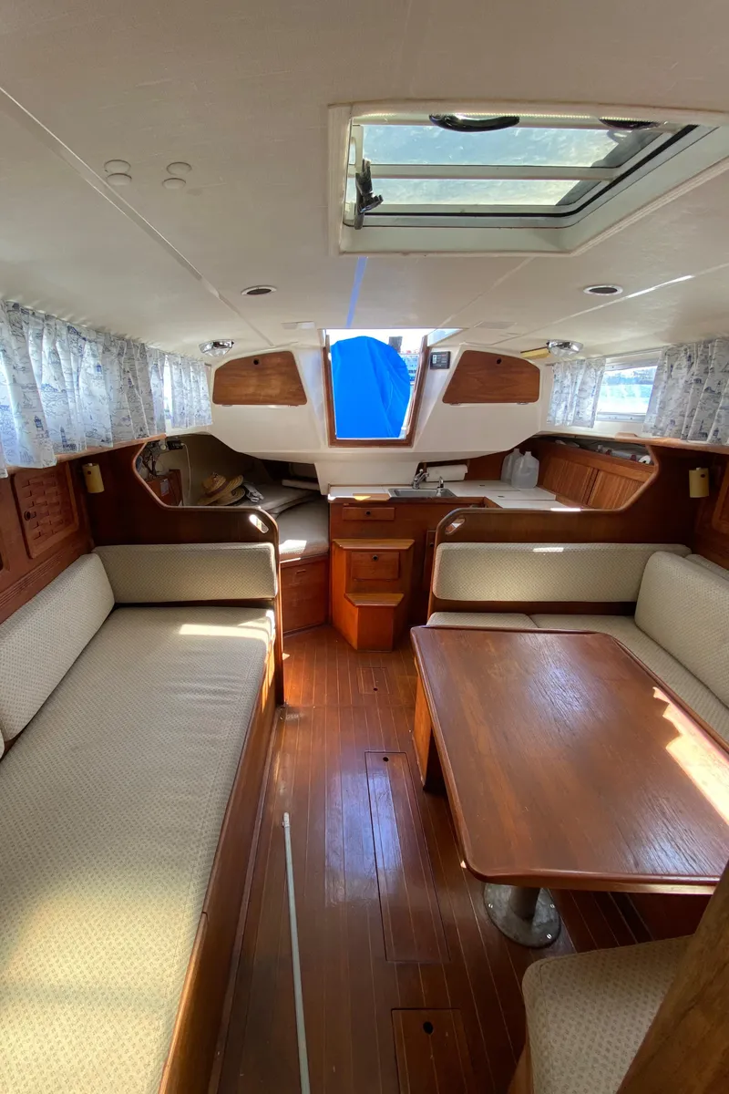 Slide: The Image of Interior of a 1985 Sabre 32 sailboat with wooden furnishings and seating area. - 18