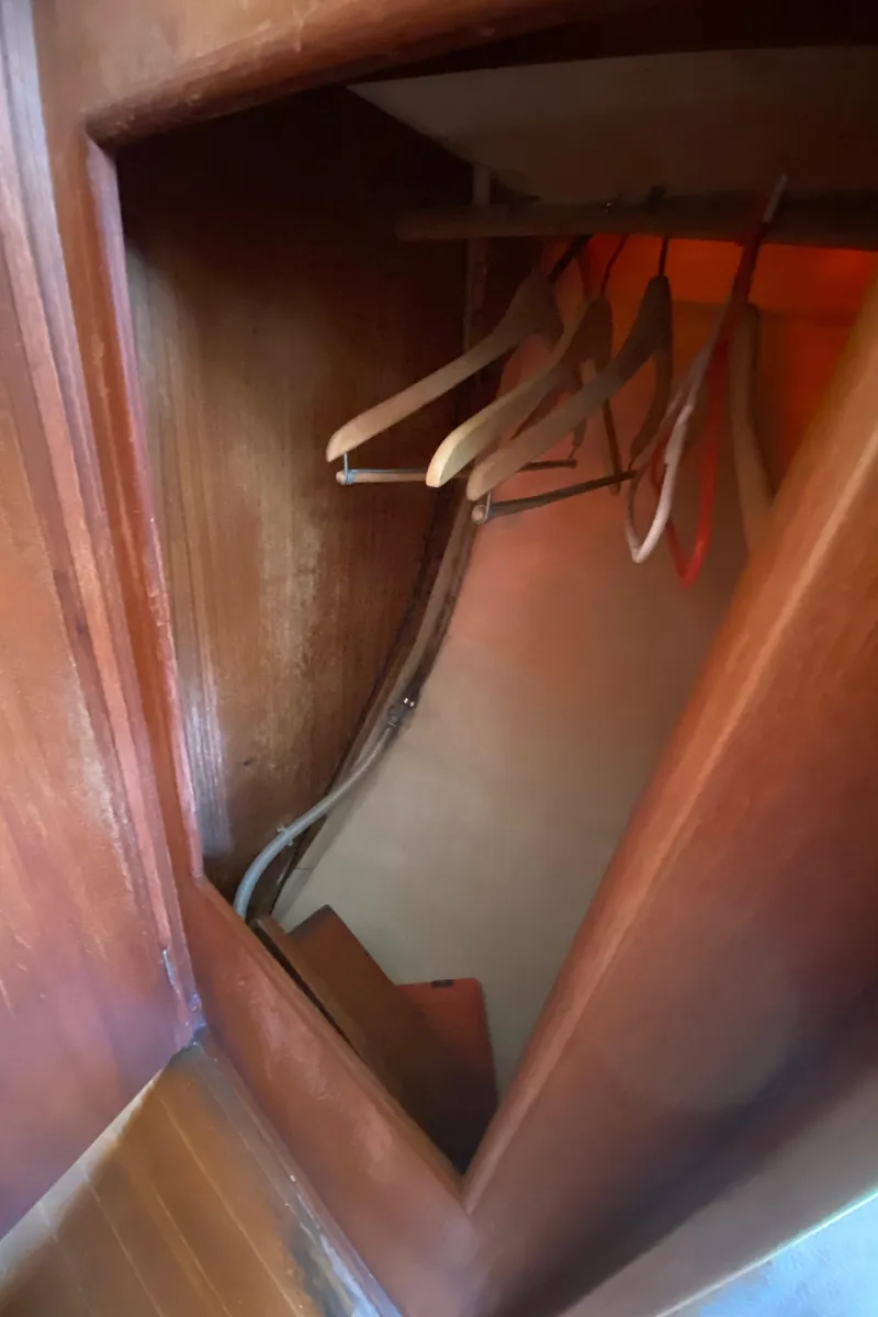 Slide: The Image of Wooden closet with hangers in a 1985 Sabre 32 sailboat. - 22