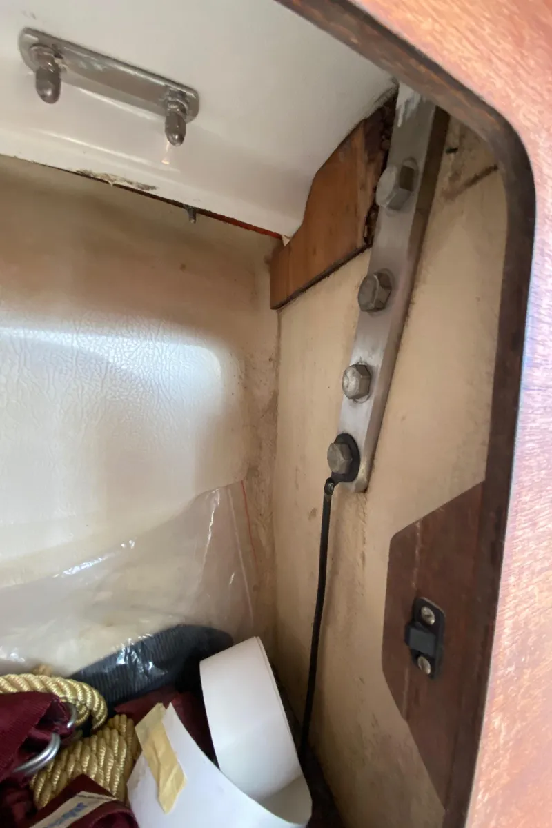 Slide: The Image of Interior view of a 1985 Sabre 32 sailboat showing storage area and structural components. - 23